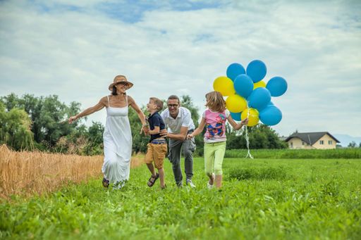 A happy family running in a field