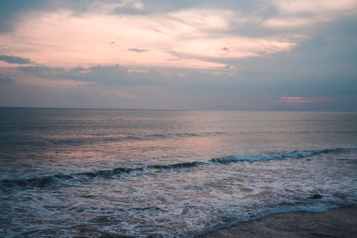 The soft ocean waves with foam on a sandy beach