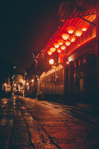 A vertical shot of illuminated lanterns hanging in an alley in Jiaxing, China