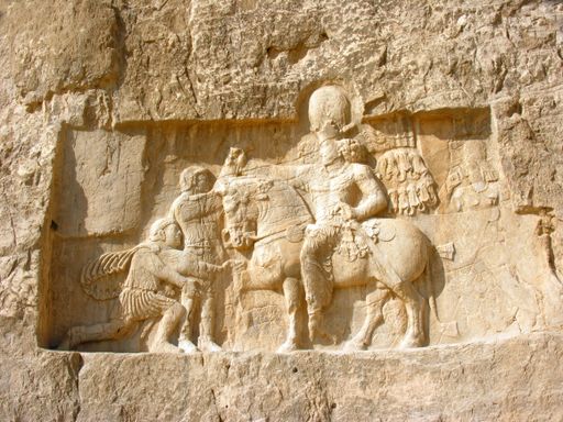A stone carving in bas-relief on the Tomb of Darius the Great at Persepolis, Iran