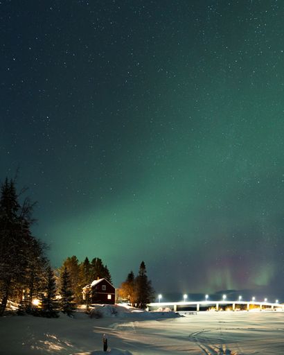 A vertical shot of aurora borealis (northern lights) in Sweden in winter looking mesmerizing