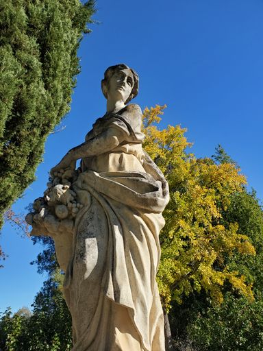 A low-angle shot of Pomona goddess statue in the garden