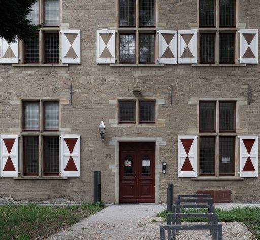 An old building with a brown entrance door and windows