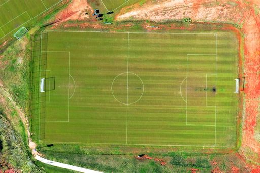 An aerial drone footage of a football field with another fields next to it