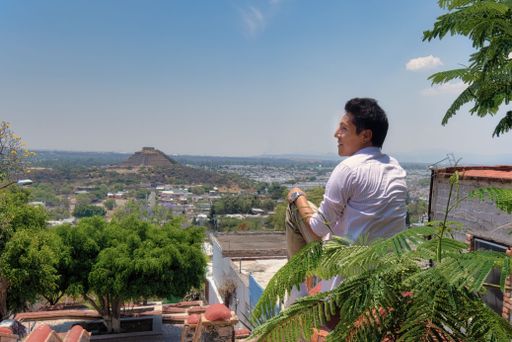 A Young man at El Pueblito pyramid Quetaro Mexico archaeological zone Mayan ruins Hispanic town