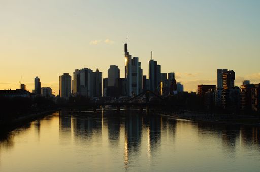 Silhouette of the Frankfurt banking district in the winter sunset, refected on the river Main.