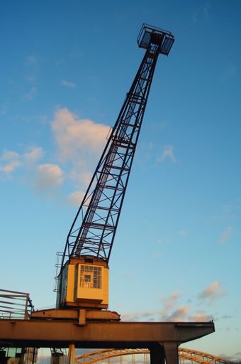 An old harbour crane at Osthafen Frankfurt, Germany in the winter sunset. Preserved as an industrial monument.