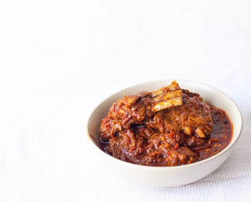 A shot of the mutton curry meal on a white background