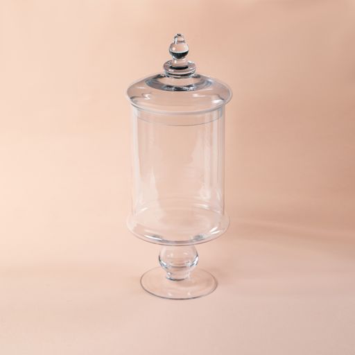 A glass sweets jar on a beige background
