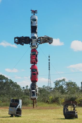 A vertical shot of a cross of cars topped with a motorcycle to impact the importance of driving safely