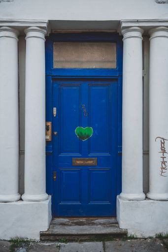 A vertical view of an old blue wooden door at Notting Hill, London, England