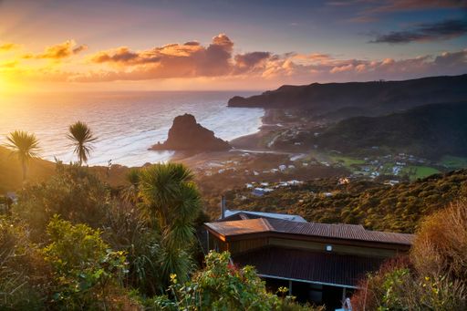 Sunset over looking Piha beach and Lion rock, West coast Auckland, New Zealand