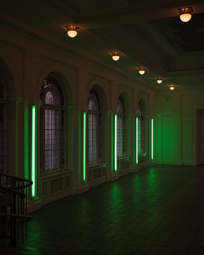A vertical perspective shot of a classic styled interior illuminated with green led lights.