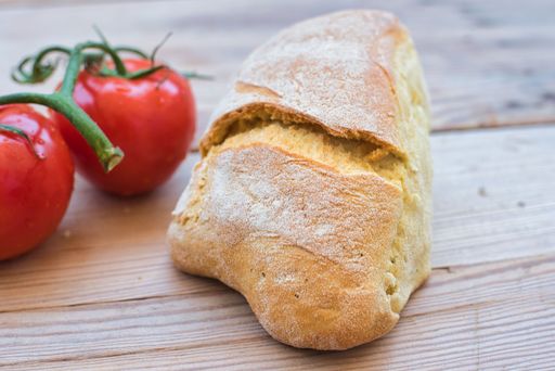 delicious fresh bread, made in a wood oven, traditional village bread on a wooden table