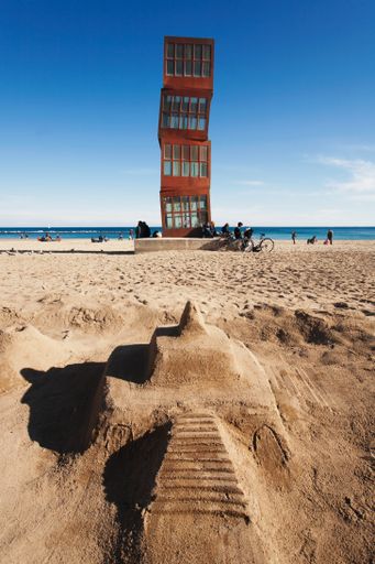 Sandcastle at Barceloneta beach in front of the monument called "Homenatge a la Barceloneta" by the artist Rebecca Horn on la Barceloneta beach