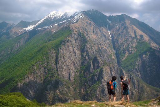 Two female hikers pointing and looking at a beautiful view from a mountain top