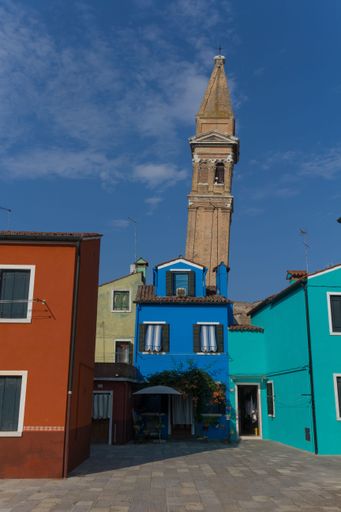 A vertical shot of colorful buildings along the streets of Venice in Italy during the daytime