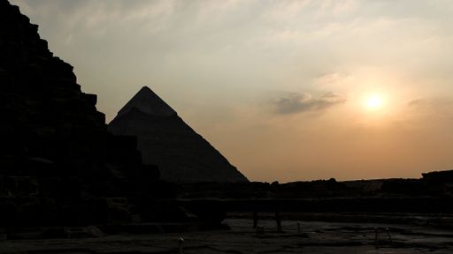 A sunset view of the Great Pyramids of Giza in Giza Egypt