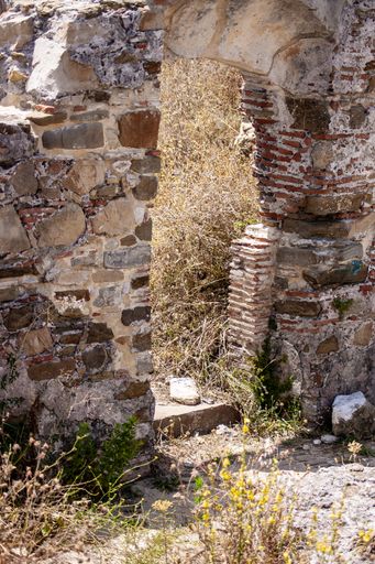 A vertical shot of an old abandoned building captured on a sunny day