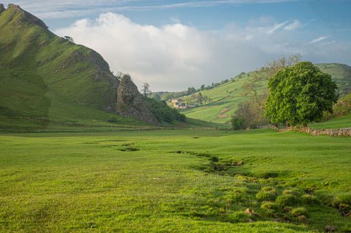 A scenic view of a rocky landscape covered with hills at sunset