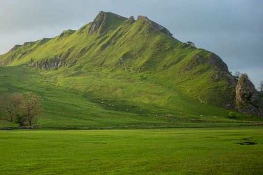 A scenic view of a rocky landscape covered with hills at sunset