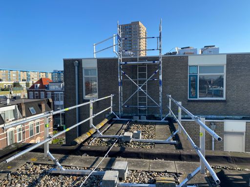 A beautiful shot of a building and some metal scaffolds in a daytime with a blue sky