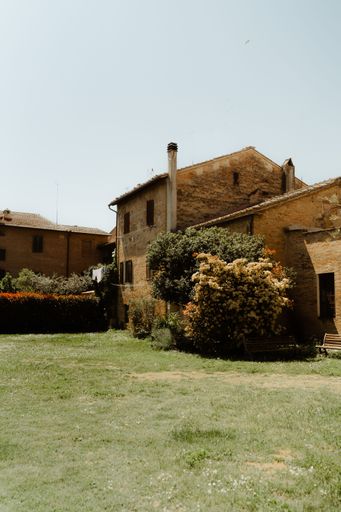 A beautiful view of a beautiful garden outside a small house in a village town with trees