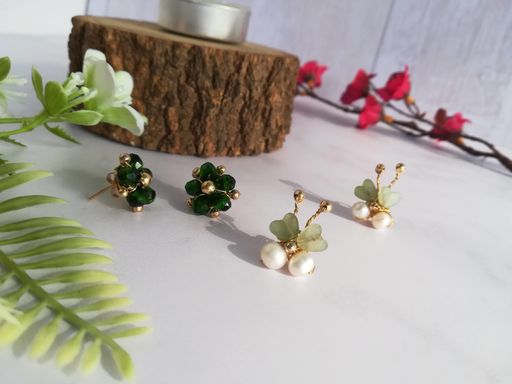 A selective focus shot of a pair of beautiful earrings on a white surface