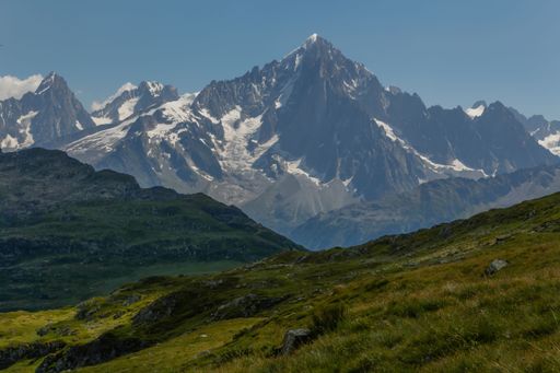 The majestic Mont Blanc mountain as seen from a grassy slope