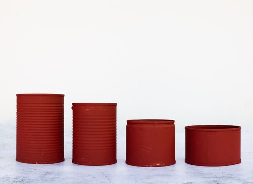 A closeup of red cans in different sizes isolated on a white background
