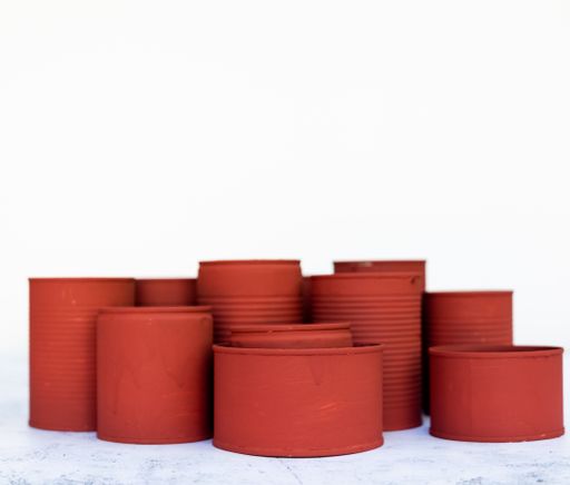 A closeup of red cans in different sizes isolated on a white background