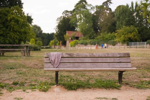 A closeup of a wooden bench in the park
