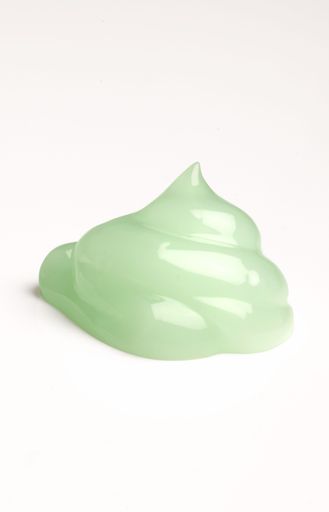 A vertical shot of a green skincare cream drop texture - advertising