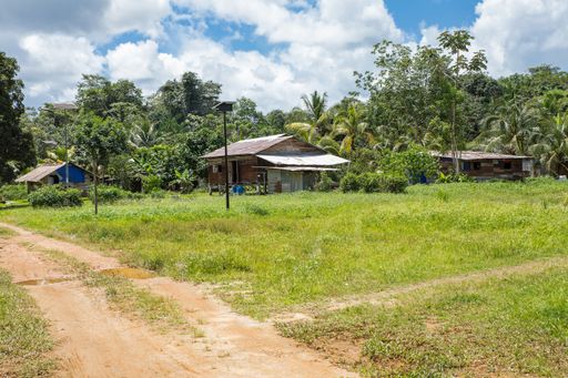 Riverside Amerindian village, Hayam, French Guiana, France with solar panels. Houses built above ground on piles. Laterite streets