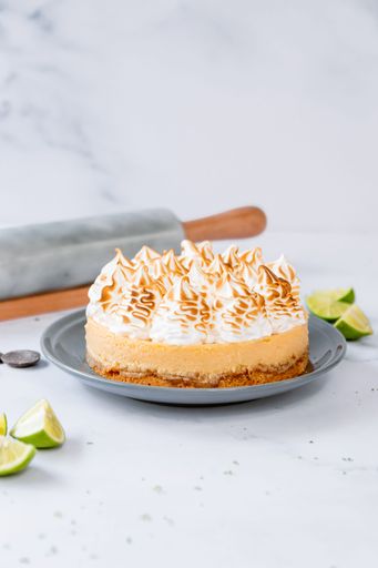 A vertical shot of a yummy lemon cake decorated with whipped cream