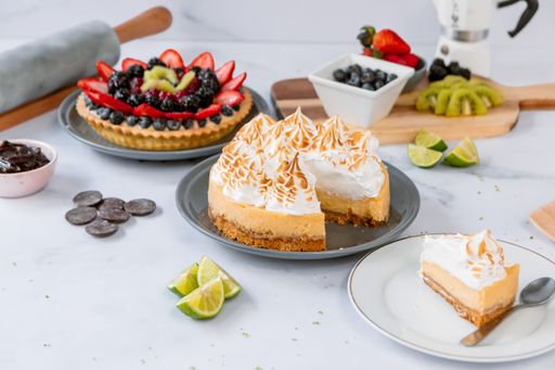 A high angle of various delicious cakes on the white surface