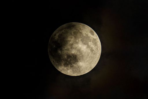 Glowing full moon in a dark sky