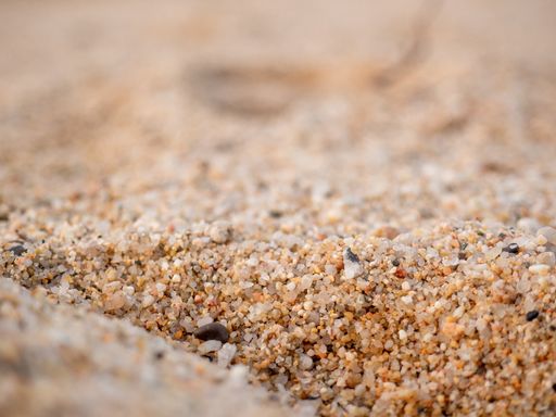 A selective focus shot of a sandy surface - perfect for background