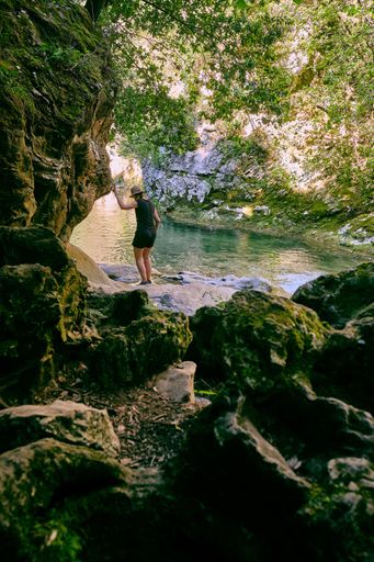 A vertical shot of someone near the lake in Arche de Ponadieu wildlife park, located in Alpes Maritimes, France