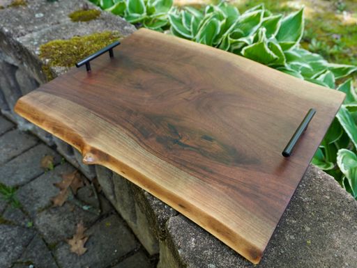 A closeup of a wooden tray on a stone surface