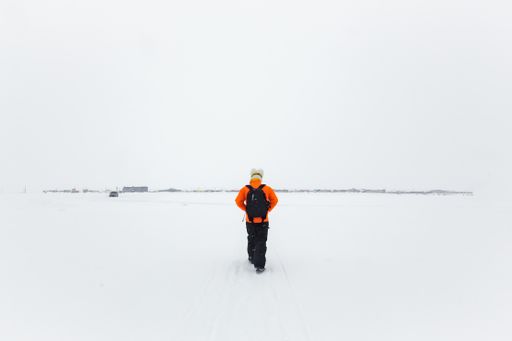 A man walking through the snow in the Arctic Circle near Barrow, Alaska