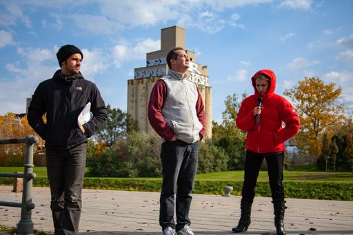 Montreal, Quebec / Canada - October 16 2010: Reporter Wearing a Red Clothes is Holding a Microphone in her Hand for Recording a TV News Story next to