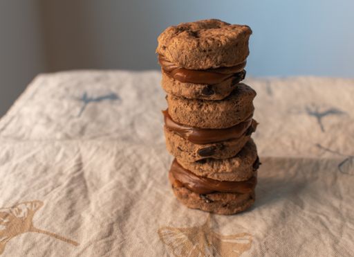 A closeup of stacked chocolate sandwich cookies on the table