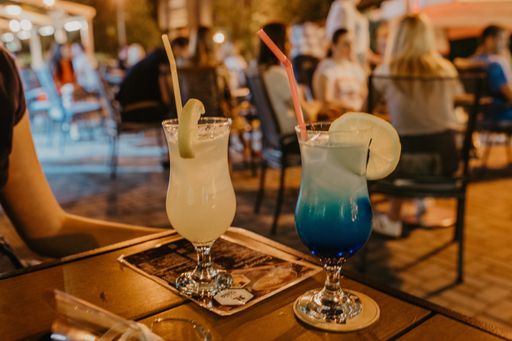 A closeup shot of cocktails on an outdoor cafe at the evening