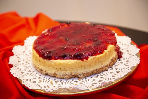 A closeup shot of a cake with strawberry jam on the top
