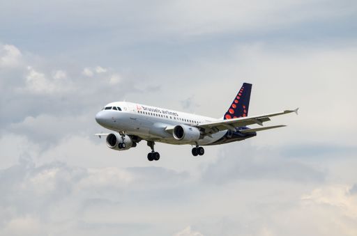 A closeup of Airbus A319 plane of the Brussels Airlines company in midflight against a cloudy sky