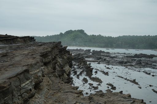 A closeup shot of beach reefs holding back the waves in Bali, Indonesia