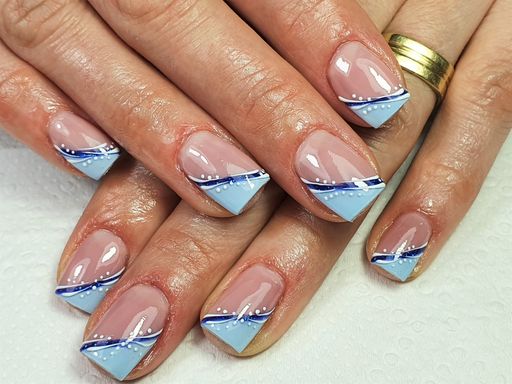 A closeup of a woman's professionally manicured fingernails painted with gel
