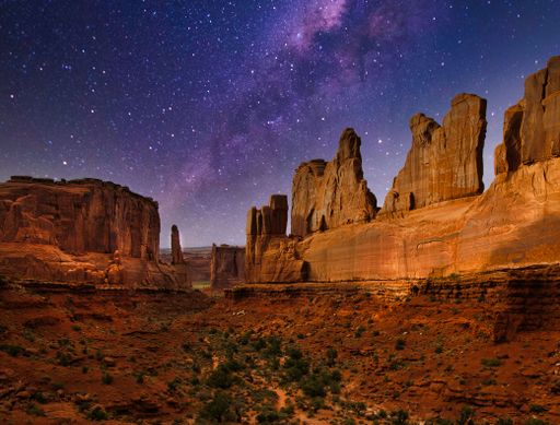 A beautiful view of the Arches National Park under the Milky Way sky
