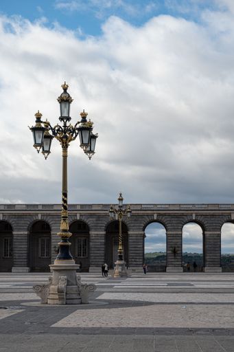 A vertical shot of the courtyard of the royal palace in Madrid under a clear sky with clouds